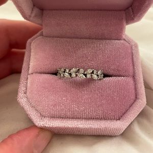 Moissanite and white gold eternity band